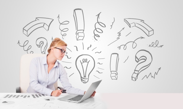 Attractive young businesswoman brainstorming with drawn arrows and symbols